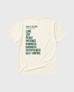 An off-white short-sleeve t-shirt shown from the back, featuring a dark green printed list of biblical virtues (Love, Joy, Peace, Patience, Kindness, Goodness, Faithfulness, Self-Control) under the heading 'FRUIT OF THE SPIRIT' and 'MATTHEW 5:3-10'.